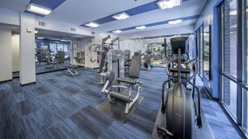 A gym with cardio equipment in a building